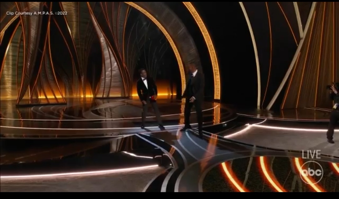 Will Smith slaps Chris Rock onstage during Oscars live