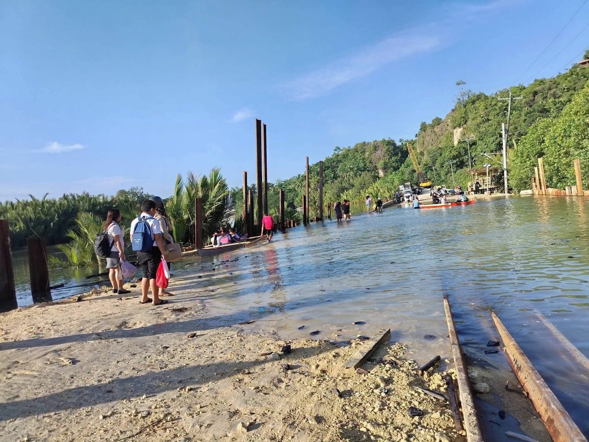 Residents continue to face risks crossing damaged Bato Bridge during high tide